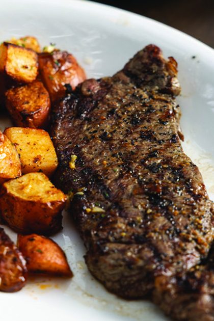 Steak with roasted potatoes at MudHen Brewing Company